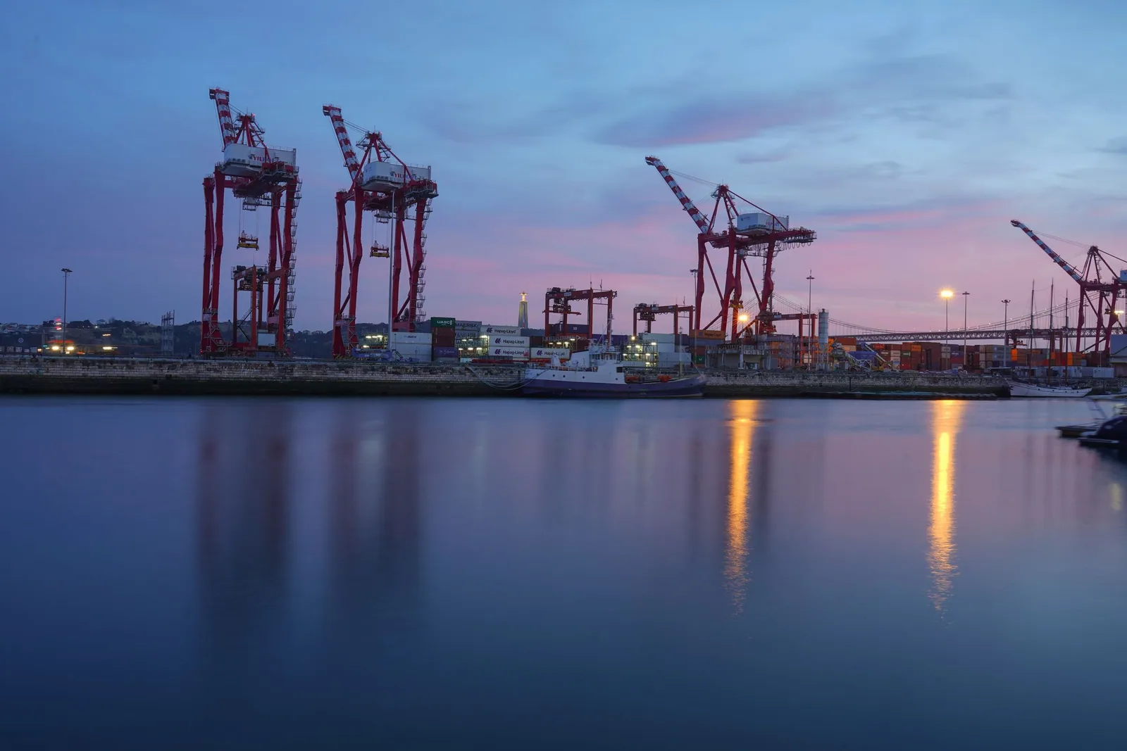 Port cranes at sunset representing international trade